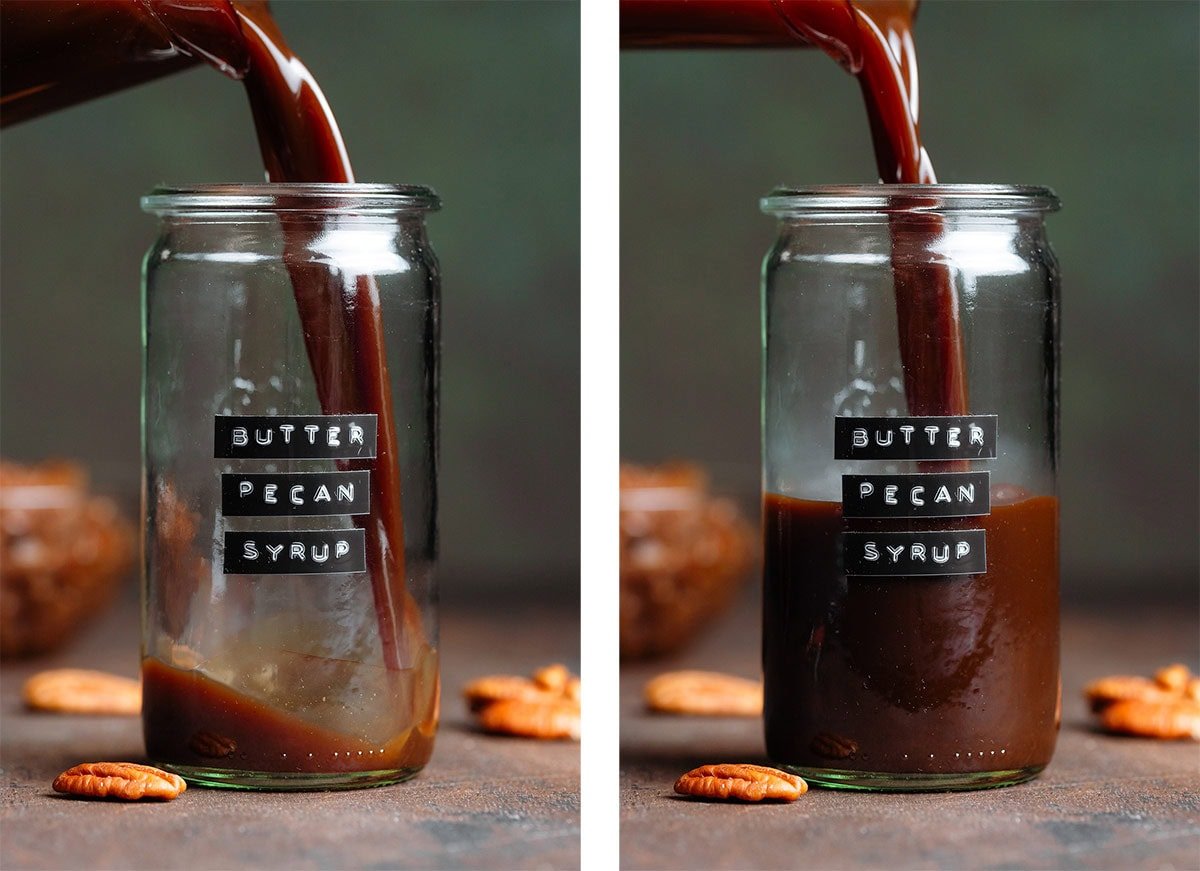 Dark brown syrup being poured into a glass jar with an embossed label that says butter pecan syrup.