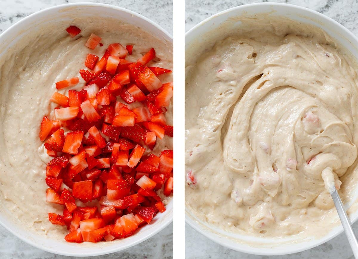 Fresh chopped strawberries added and stirred into pancake batter in a large white bowl.