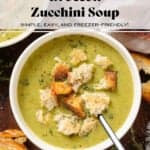 Creamy green broccoli soup in white bowls garnished with torn up toasted sourdough bread and fresh thyme.