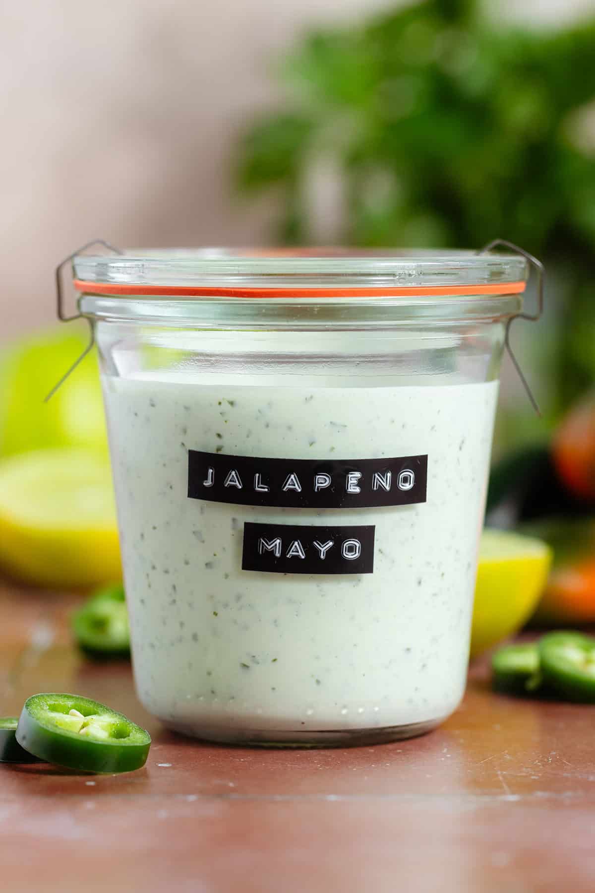 Jalapeno mayo in a jar with an embossed black and white label.