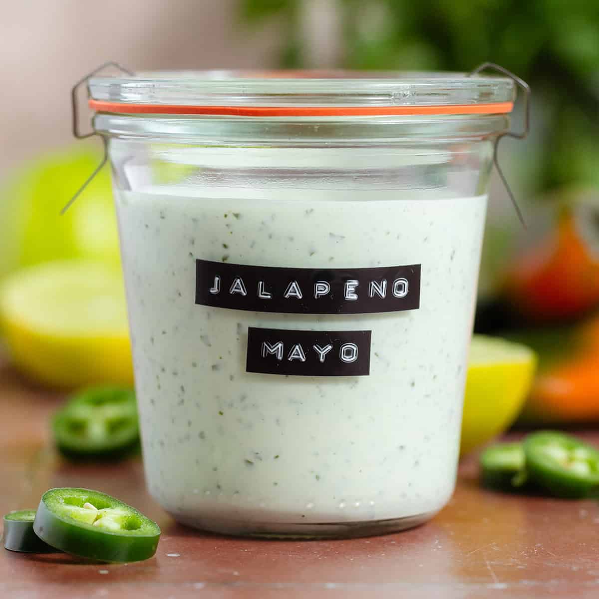 Jalapeno mayo in a jar with an embossed black and white label.