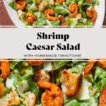 Caesar salad with spicy shrimp on a large oval serving platter.