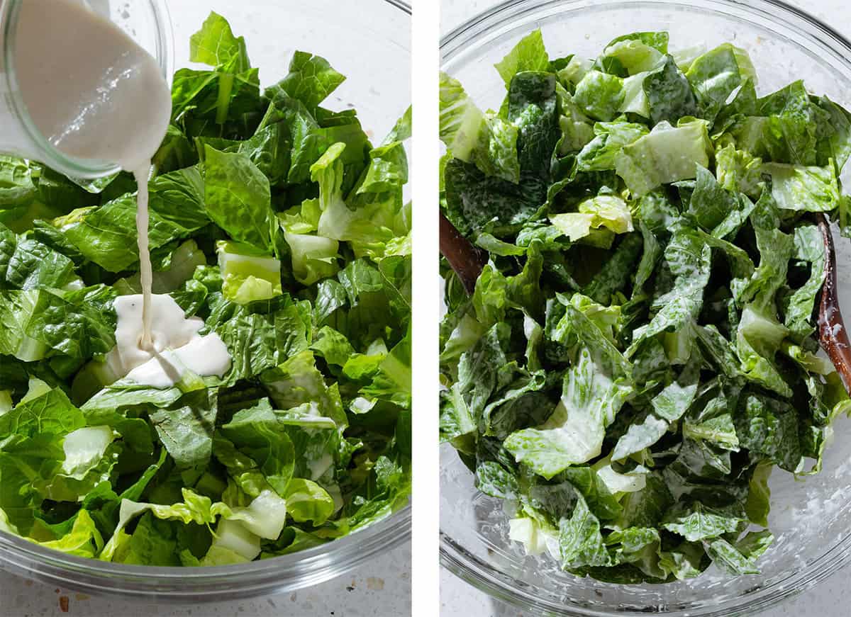 Caesar dressing being poured into a large bowl with chopped romaine lettuce.