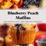 Two blueberry peach muffins stacked with more muffins, peaches, and blueberries behind them.