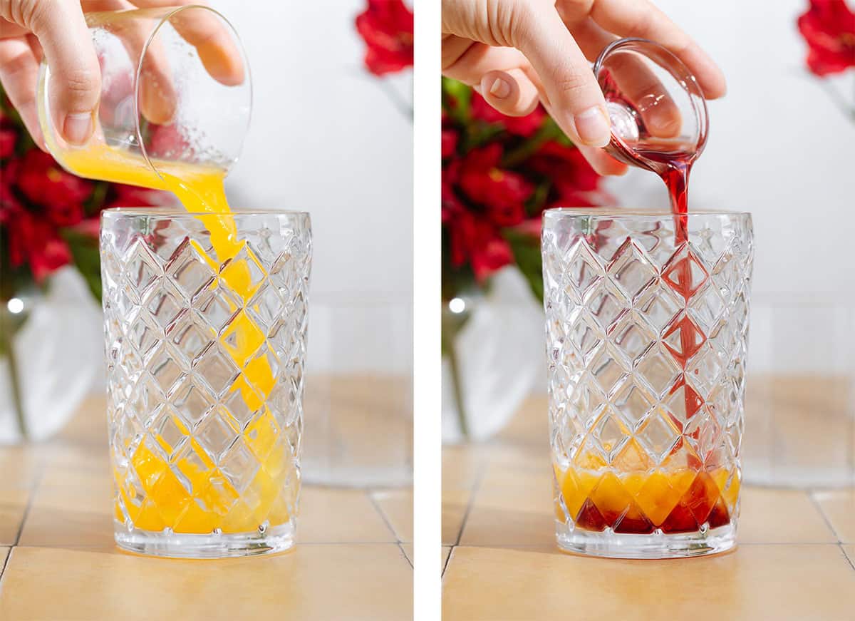 Orange juice and hibiscus syrup being poured into a glass cocktail shaker.