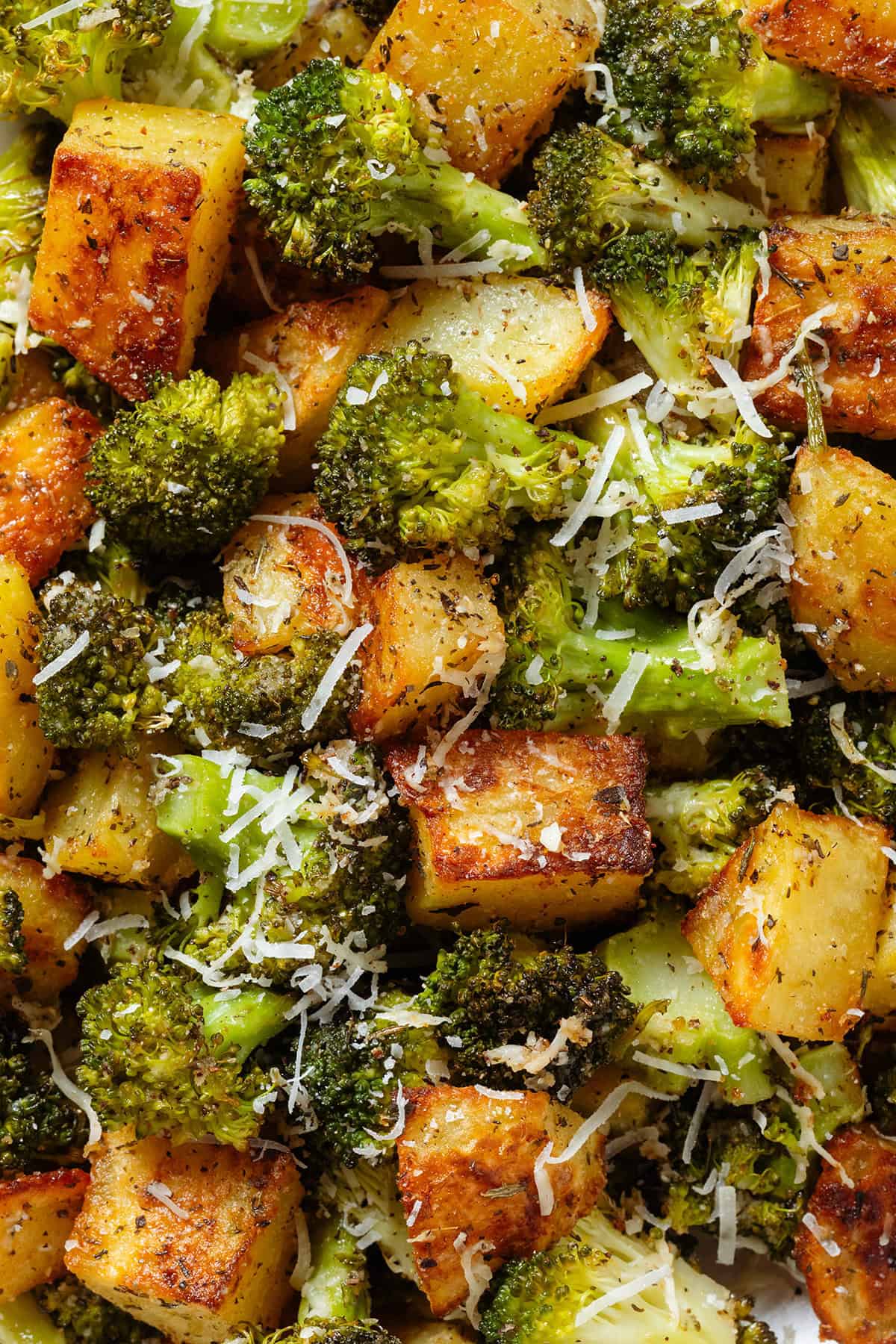 Roasted broccoli florets and crispy diced potatoes sprinkled with grated parmesan.