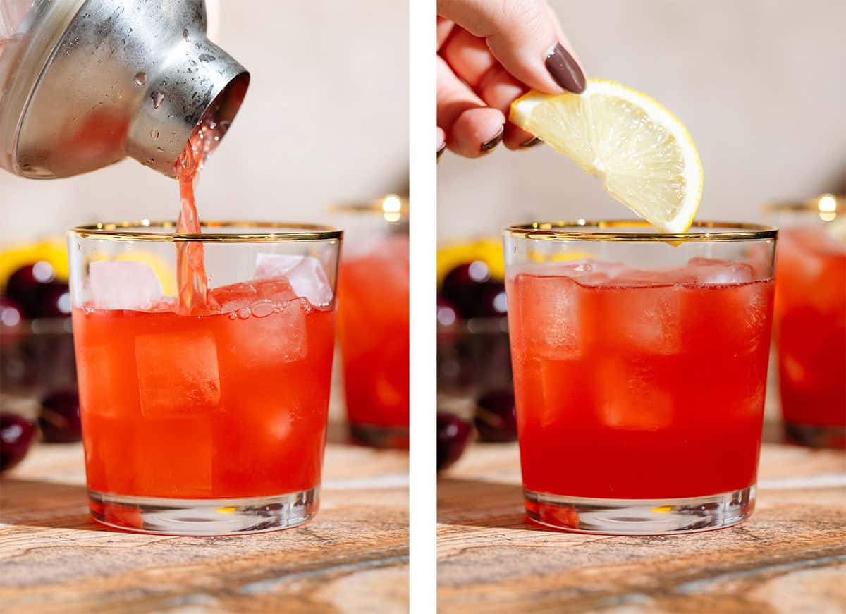 Red cocktail being strained into a short glass over ice on the left and half a slice of lemon being added on top on the right.