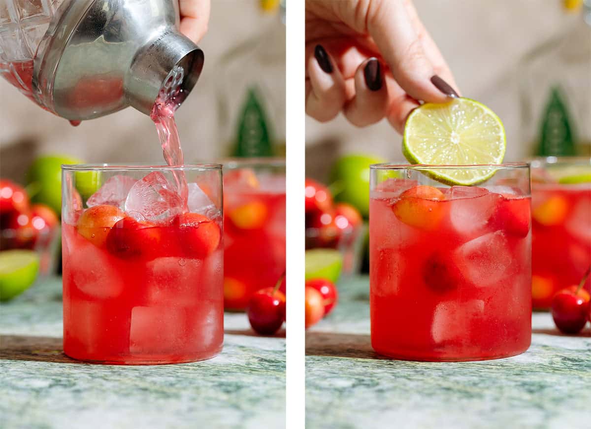 Bright red drink being strained into a short glass over ice on the left and a slice of lime being added on the right.