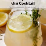Light yellow thyme gin cocktail in a short glass with ice garnished with fresh thyme and a lemon slice.