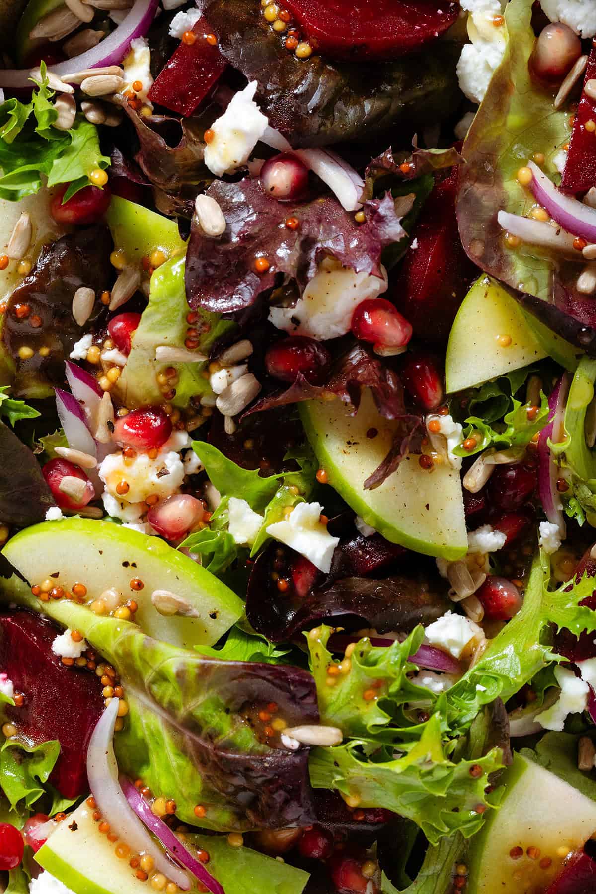 Salad with steamed beets, sliced apple, goat cheese, pomegranate arils, goat cheese, and whole grain mustard vinaigrette.