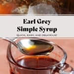 Dark brown earl grey syrup in a large glass measuring cup with a spoon picking up some of the syrup.