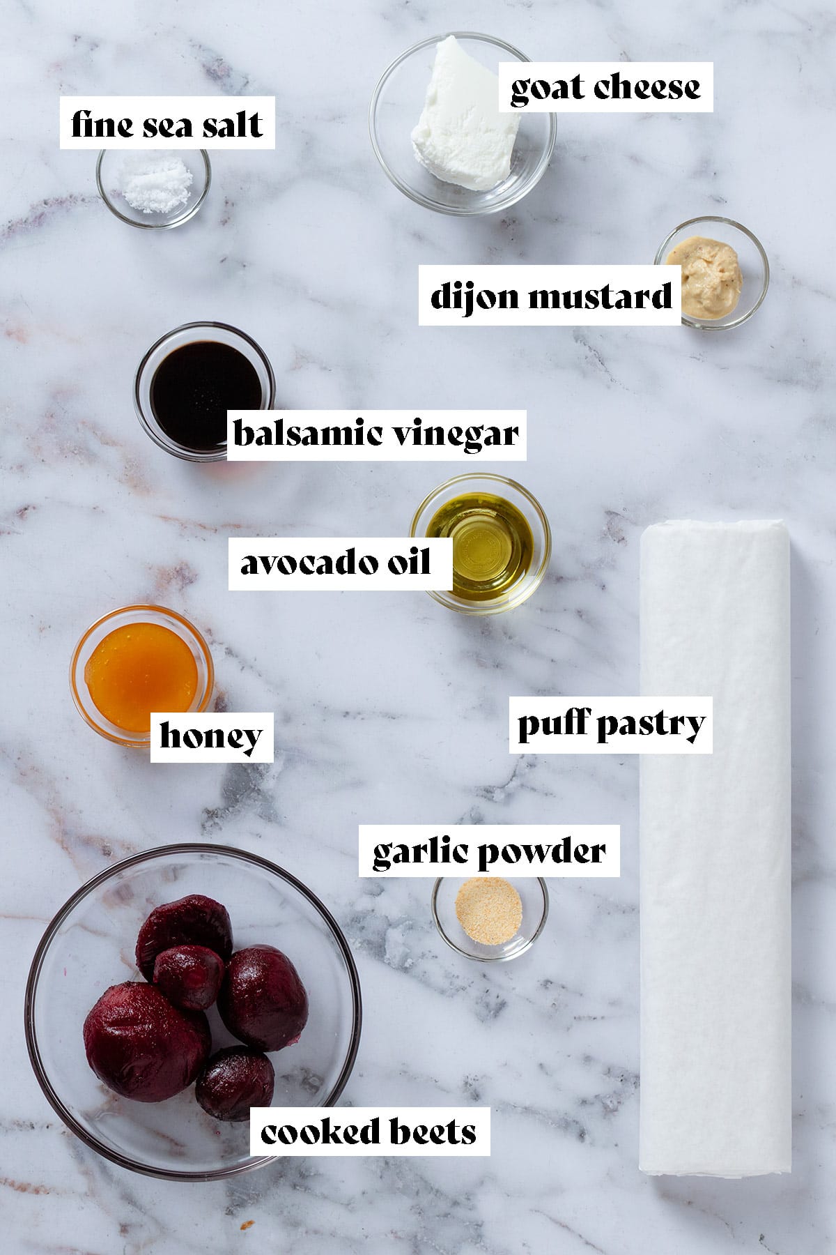 Roll of puff pastry and various ingredients in glass bowls like cooked beets, goat cheese, olive oil, honey, and spices with text overlay.