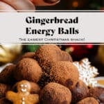 Energy balls rolled in cocoa powder stacked on a small beige plate garnished with mini gingerbread cookies and a hand grabbing one ball.