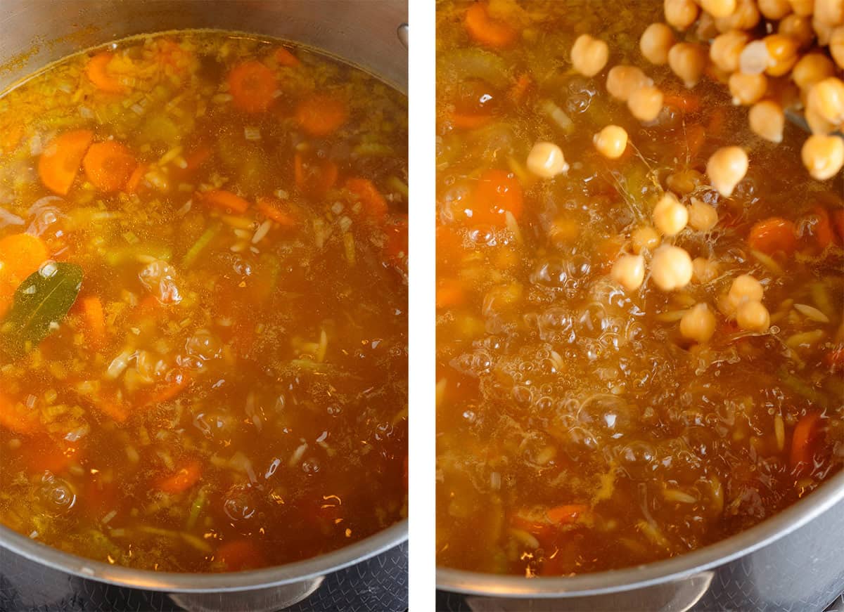 Soup with vegetables and orzo simmer in a large pot and cooked chickpeas being tossed in on the right.