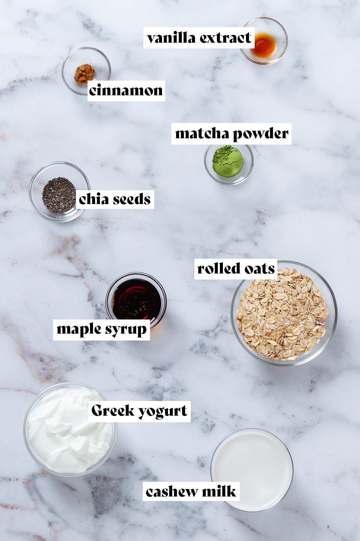 Ingredients like rolled oats, yogurt, milk, maple syrup matcha powder, and chia seeds in small glass bowls with text overlay.