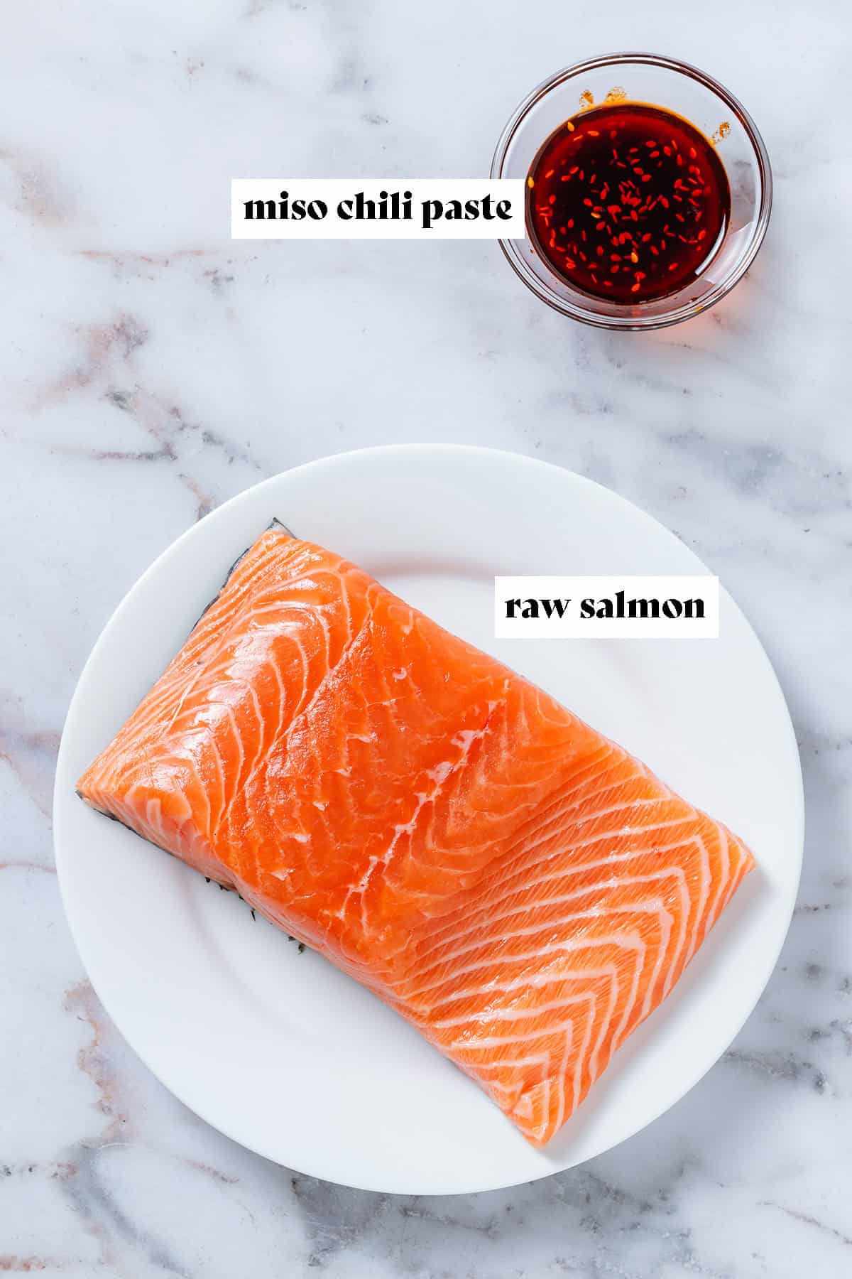 Raw salmon on a white plate and miso chili paste in a small glass bowl with text overlay.