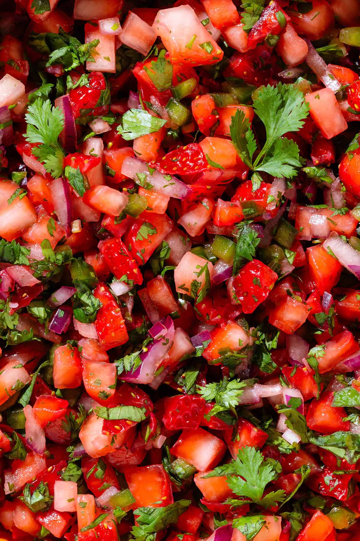 Fresh strawberry salsa with lots of cilantro, jalapenos, and red onion.