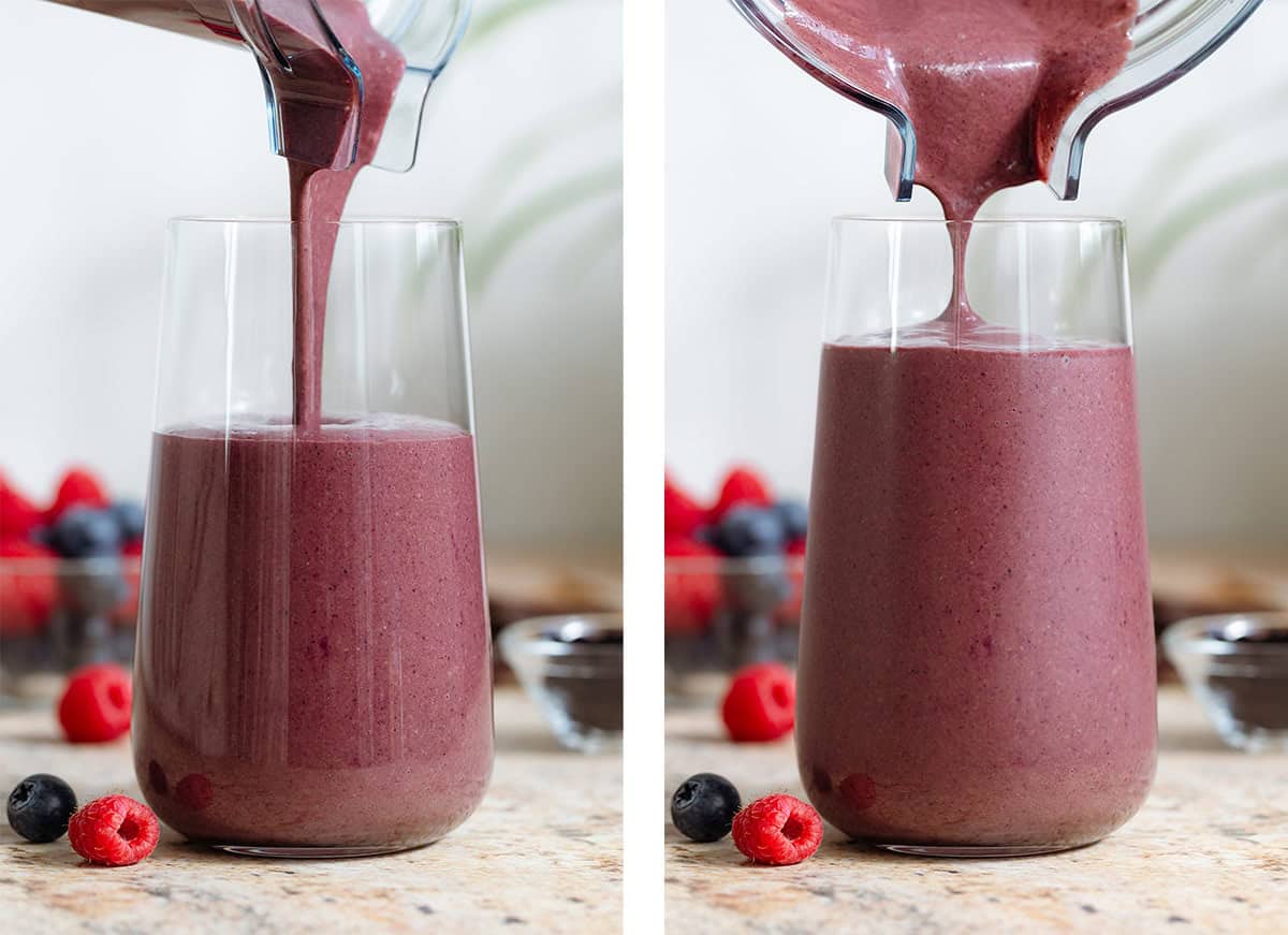 A chocolate acai smoothie being poured into a tall glass from a blender container.