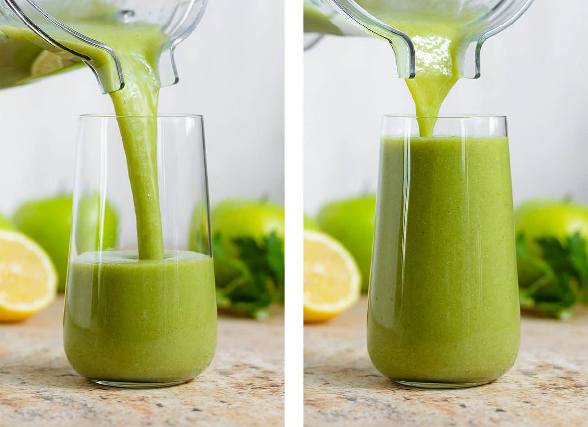 Green smoothie being poured into a tall glass from a blender container.