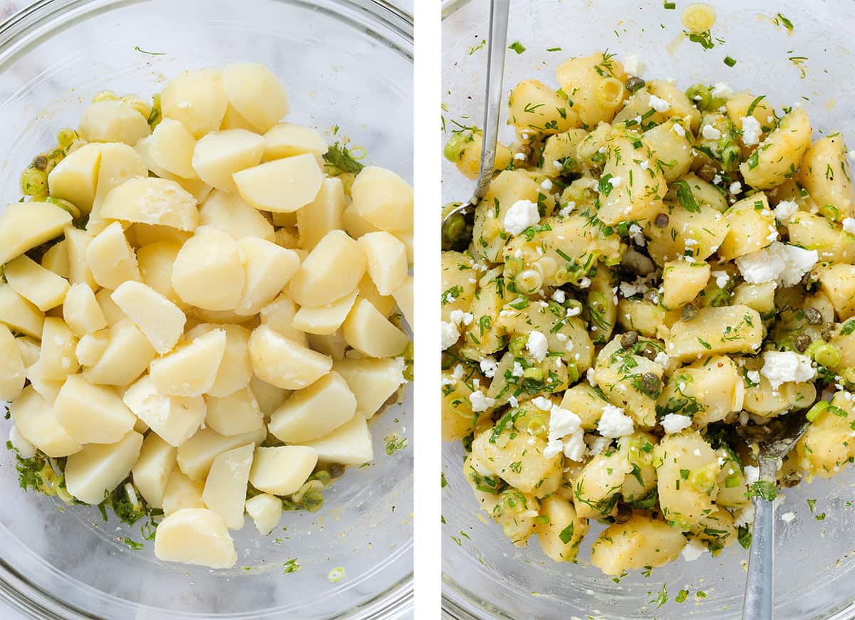 Diced boiled potatoes being tossed with chopped herb vinaigrette and feta in a large glass bowl.