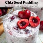 Cherry chia pudding in a small glass garnished with one whole cherry and one cherry sliced in half and pitted, with text overlay.
