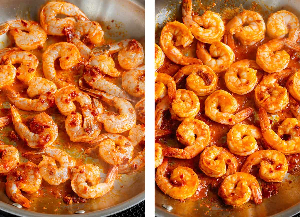 Raw shrimp with harissa marinade cooking in a large stainless steel skillet.