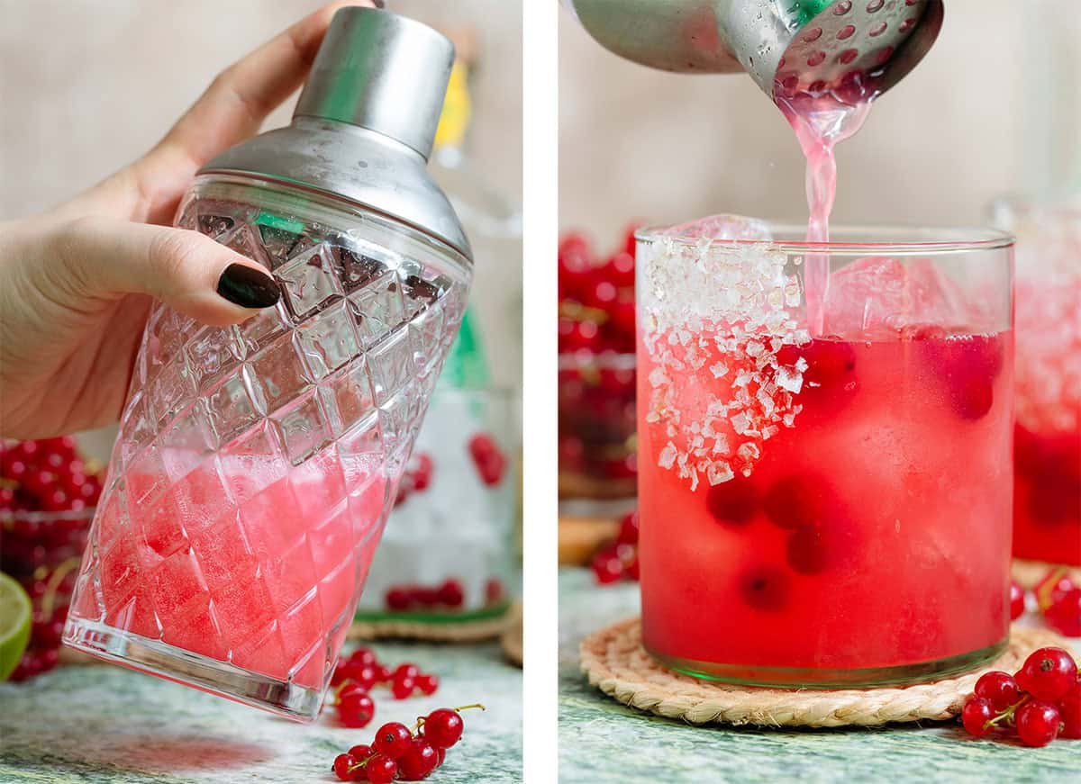 Red margarita being shaken in a glass shaker and strained into a short glass over ice.